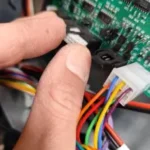 Nahaufnahme eines Technikers beim Umbau der Platine SVE02 im SandenVendo Automaten